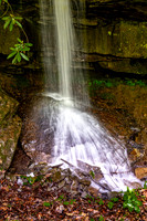 Waterfall Cascading Over Mossy Rocks in Forest
