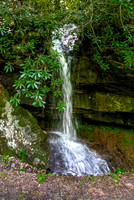 Small Waterfall Cascading Over Mossy Rocks
