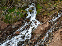 Small Waterfall Cascading Down Rocky Hillside