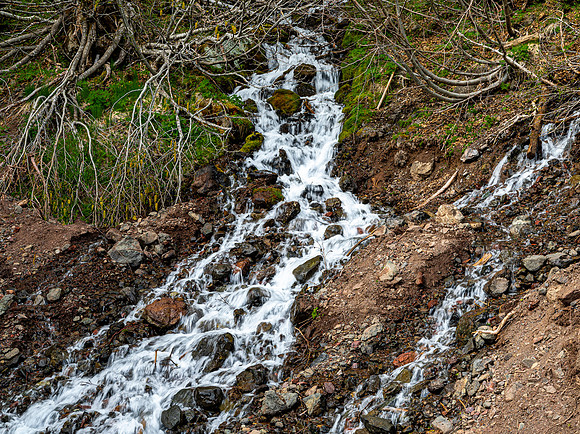 Small Waterfall Cascading Down Rocky Hillside
