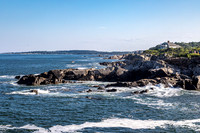 Rugged Maine Coastline with Ocean Waves and Distant Town