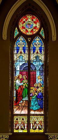 Stained Glass Window Depicting Jesus and Eucharist