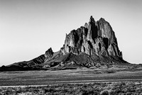 Shiprock peak, a volcanic neck, rises from desert.