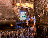 Blacksmith at Work in Traditional Forge