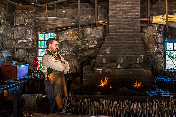 Blacksmith in Workshop with Roaring Forge