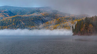 Misty Autumn Morning on a Lake with Colorful Trees