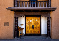 Historical Adobe Building Entrance with Ornate Wooden Door
