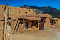 Traditional Adobe Buildings with Mountain Background