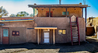 Traditional Adobe Multi-Story Building with Wooden Staircase