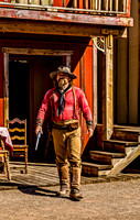 Man in Western Attire with Revolver