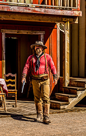 Man in Western Attire with Revolver