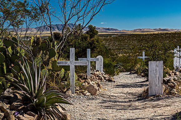 Old Cemetery with Wooden Crosses and Desert Landscape