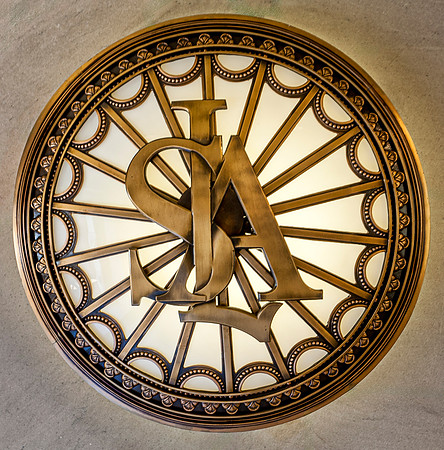 Ornate Bronze Emblem with Intertwined Letters 'SLSA'