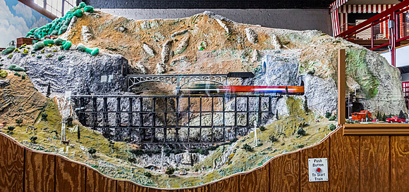 Model Train Exhibit with Mountains and Bridges