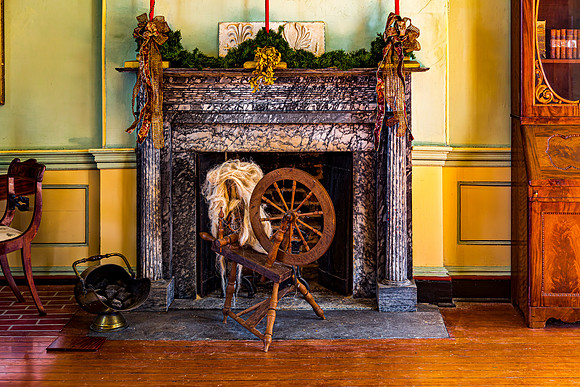 Spinning Wheel by Marble Fireplace