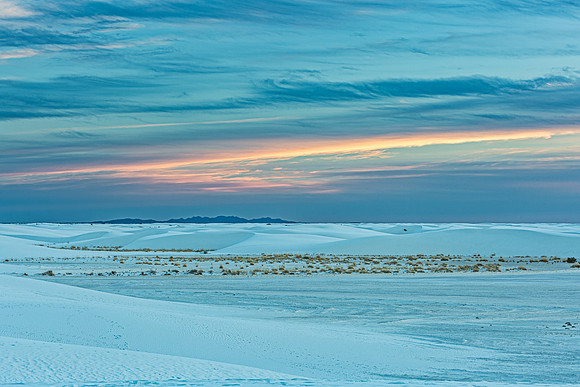 White Gypsum Dunes at Sunset with Distant Mountains