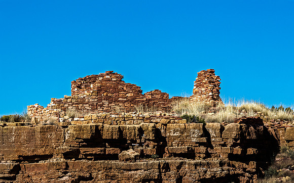 Ancient Stone Ruins on Cliff Under Blue Sky