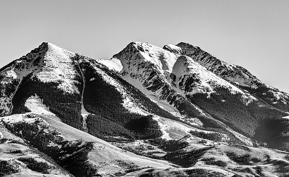 Snow-Capped Mountain Peaks with Forests and Foothills