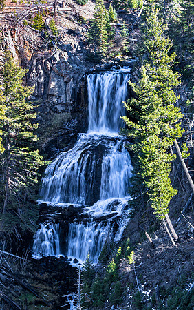 Tiered Waterfall Cascading Through Pine Trees
