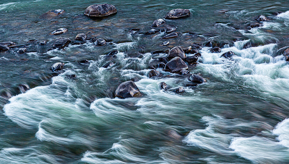 River Water Flowing Over Rocks