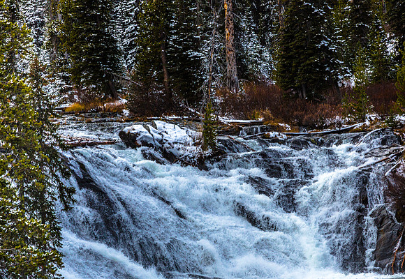 Rushing Waterfall in a Wintry Forest Landscape