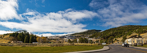 Road Through Valley with Mountains and Buildings