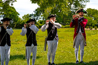 Four Men in Historical Costumes Playing Flutes