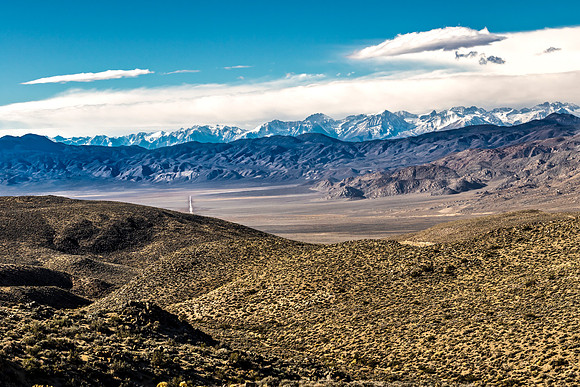 Desert Road to Snow-Capped Mountains